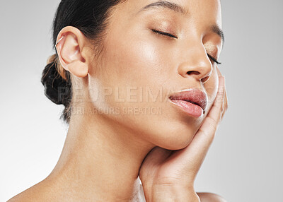 Buy stock photo Studio shot of an attractive young woman posing against a grey background