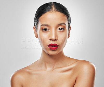 Buy stock photo Studio portrait of an attractive young woman wearing red lipstick against a grey background