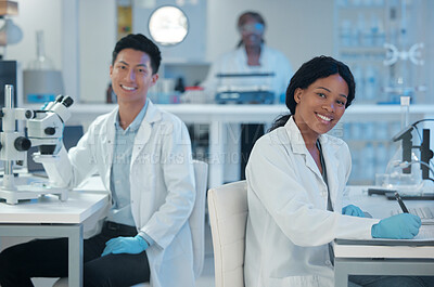 Buy stock photo Shot of two lab workers together in their office