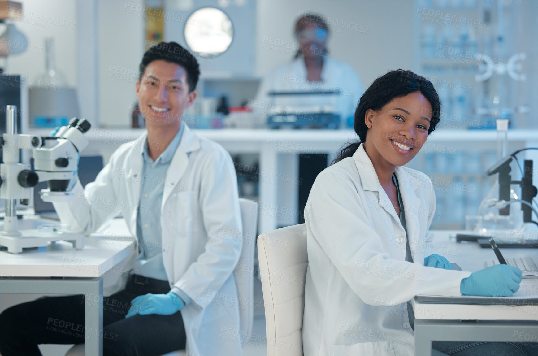 Buy stock photo Shot of two lab workers together in their office