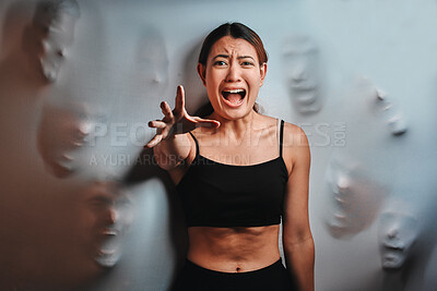 Buy stock photo Shot of a young woman experiencing mental illness against a spooky background