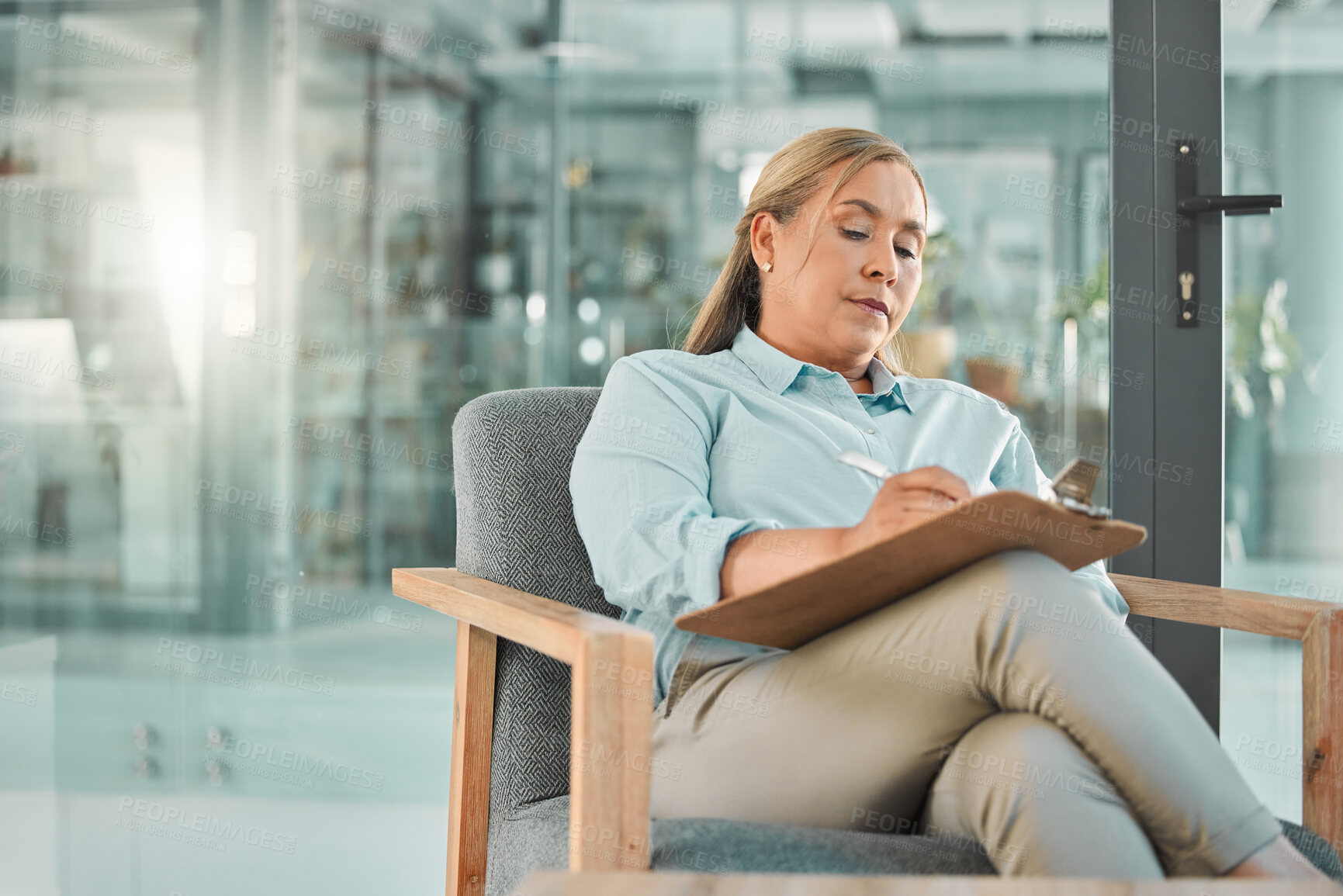Buy stock photo Psychology, writing and woman with clipboard in office for counselling, therapy session and consulting. Advice, mental health and psychologist on chair with notes, checklist and patient diagnosis