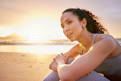 Buy stock photo Shot of a fit young woman sitting on the beach