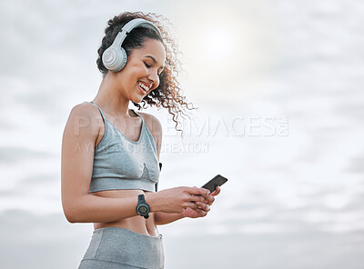 Buy stock photo Fitness, woman and smartphone with headphones outdoor for exercise music or monitor workout progress. Athlete, girl or happy with phone for listening to radio or streaming training podcast in nature