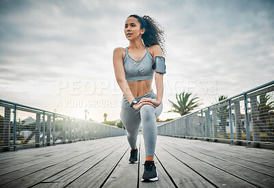 Buy stock photo Woman, legs and stretching outdoor for fitness, running and cardio exercise in morning with low angle. Female person, muscle and warm up on bridge for health, training and workout with vision or idea