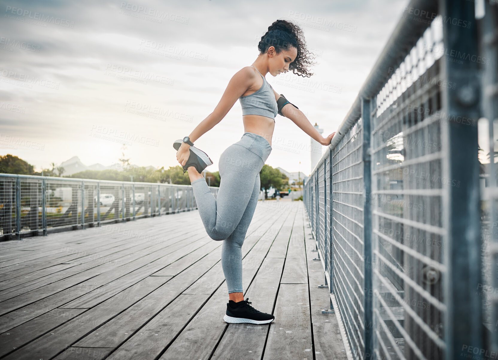 Buy stock photo Athlete, legs and stretching outdoor for fitness, running and cardio exercise in morning with flexible. Woman, muscle and warm up on bridge for health, training and workout with physical activity