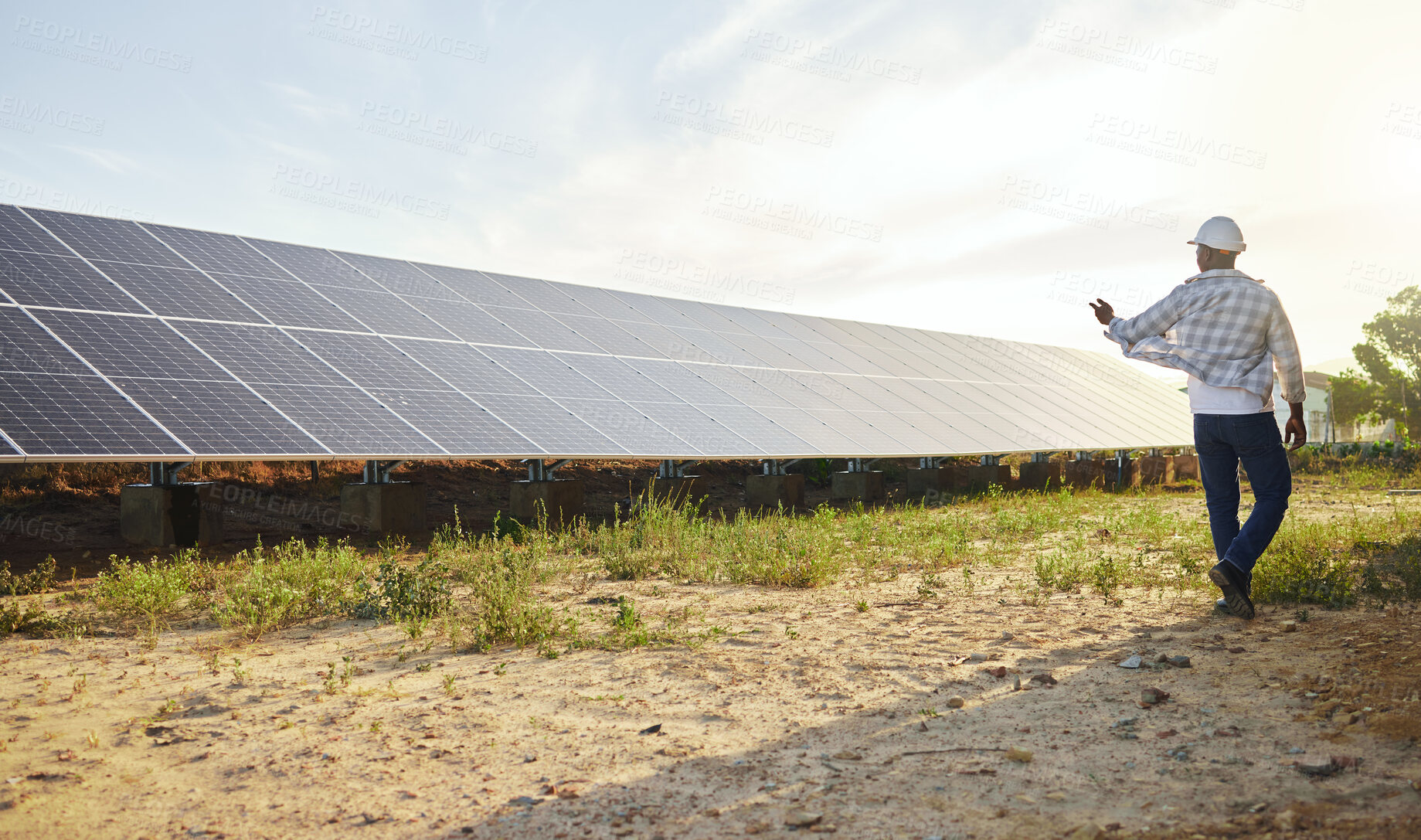 Buy stock photo Back, man and solar panel in renewable energy for ecology, sustainable and clean power. Engineer, alternative generator and carbon neutral technology in conservation, environment or green electricity