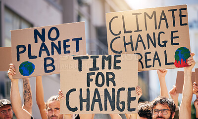 Buy stock photo Shot of a group of people holding up signs at a protest rally