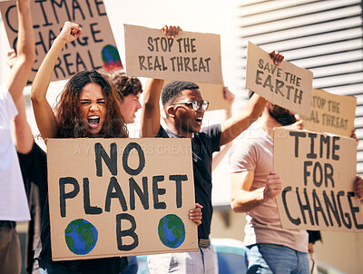 Buy stock photo Shot of a group of people holding up signs at a protest rally