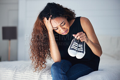 Buy stock photo Crying, depression and woman with shoes in bedroom for grief, miscarriage memory and mourn death of kid. Sad mother, tears and person on bed with pain, anxiety or trauma problem, stress or frustrated