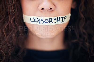 Buy stock photo Closeup shot of an unrecognisable woman with tape on her mouth that has the word 