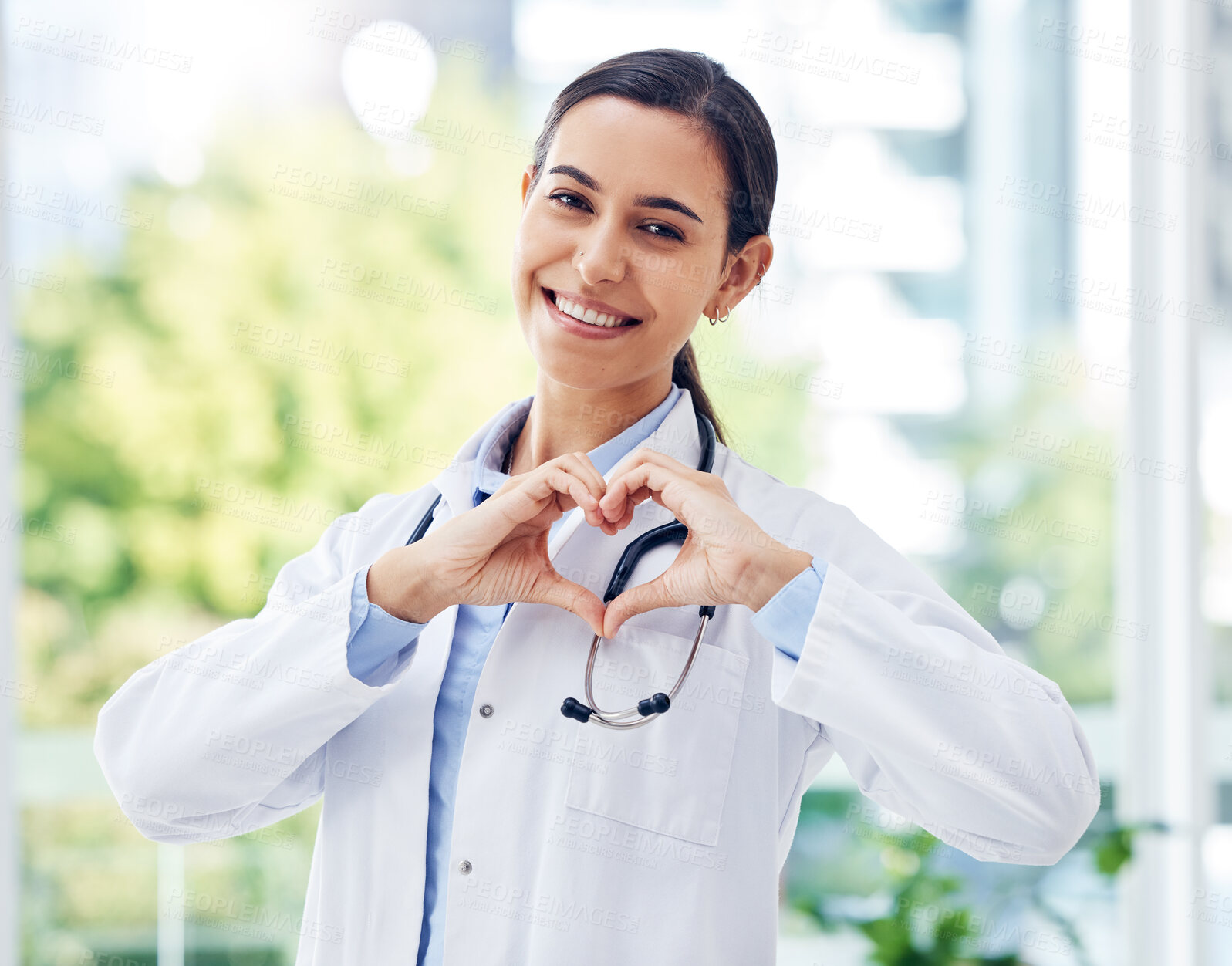 Buy stock photo Happy woman, portrait and doctor with heart hands for healthcare, service or cardiology at hospital. Female person or medical employee with shape, like emoji or love for health and wellness at clinic