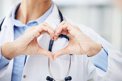 Buy stock photo Closeup shot of an unrecognisable doctor making a heart shape with her hands in a hospital