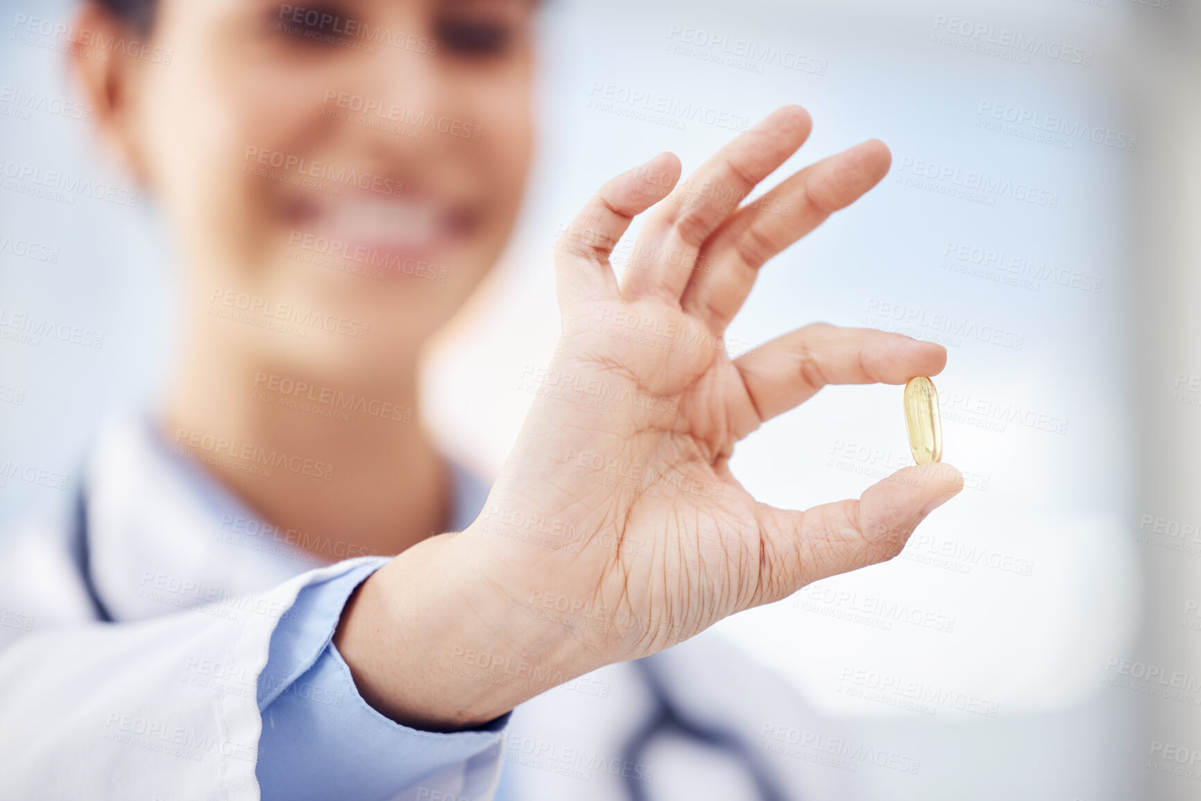 Buy stock photo Closeup shot of an unrecognisable doctor holding a pill in a hospital