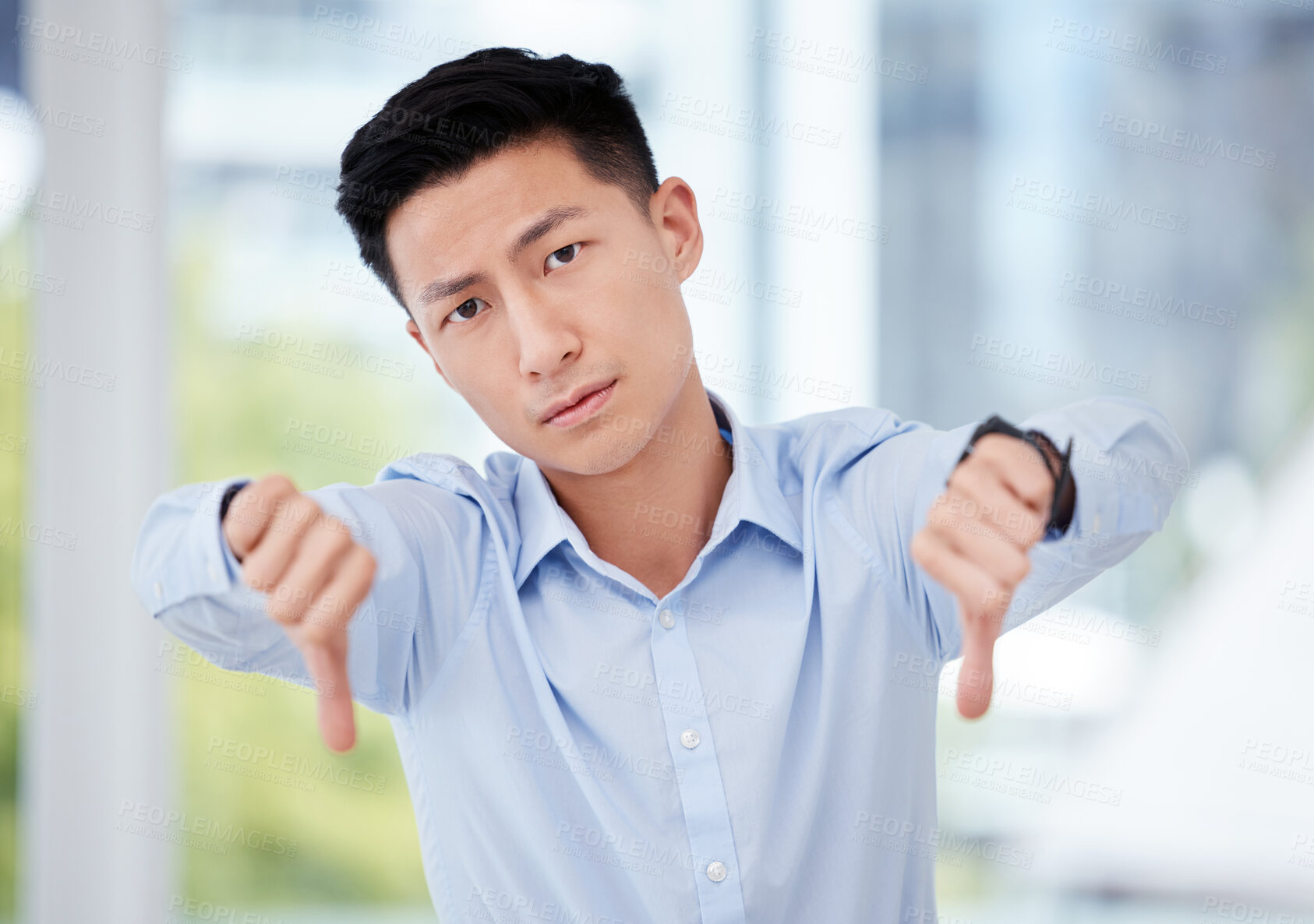 Buy stock photo Portrait, man and thumbs down in vote, opinion or choice with negative, feedback or review. Asian male person, hand gesture and show as professional, employee or staff with no, sign and disapproval