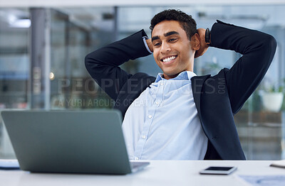 Buy stock photo Shot of a young businessman taking a break while working on a laptop in an office