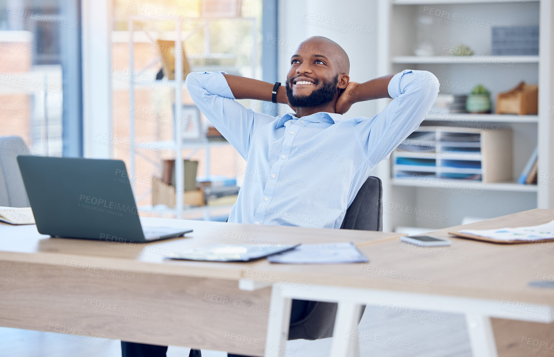 Buy stock photo Shot of a young businessman resting while working in a modern office