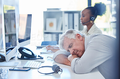 Buy stock photo Shot of a mature call centre agent sleeping at his desk in an office