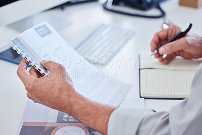 Buy stock photo Closeup shot of an unrecognisable businessman going through paperwork in an office