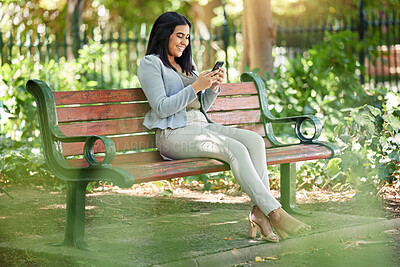 Buy stock photo Business woman, phone and texting in park on bench with smile, reading and contact on mobile app. Person, happy and smartphone with web chat, scroll and check notification on social media in Colombia