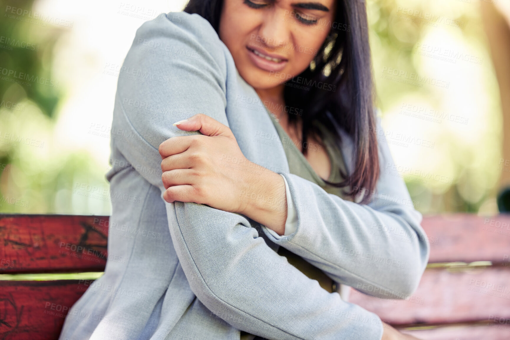 Buy stock photo Business woman, arm and injury in park with muscle cramp, strain and relief with hand for massage in summer. Person, professional and outdoor with burnout, overworked and pain with stress in Colombia