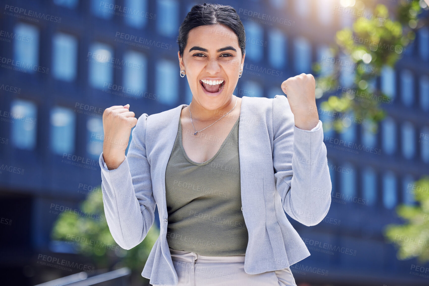 Buy stock photo Portrait of a young businesswoman cheering in the city
