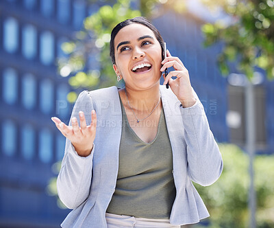 Buy stock photo Shot of a young businesswoman talking on a cellphone outdoors