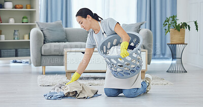 Buy stock photo Shot of a young woman cleaning up at home