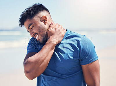 Buy stock photo Shot of a man experiencing discomfort in his neck while out for a workout