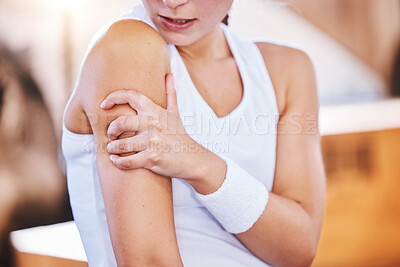 Buy stock photo Closeup shot of an unrecognisable woman experiencing arm pain while exercising in a gym