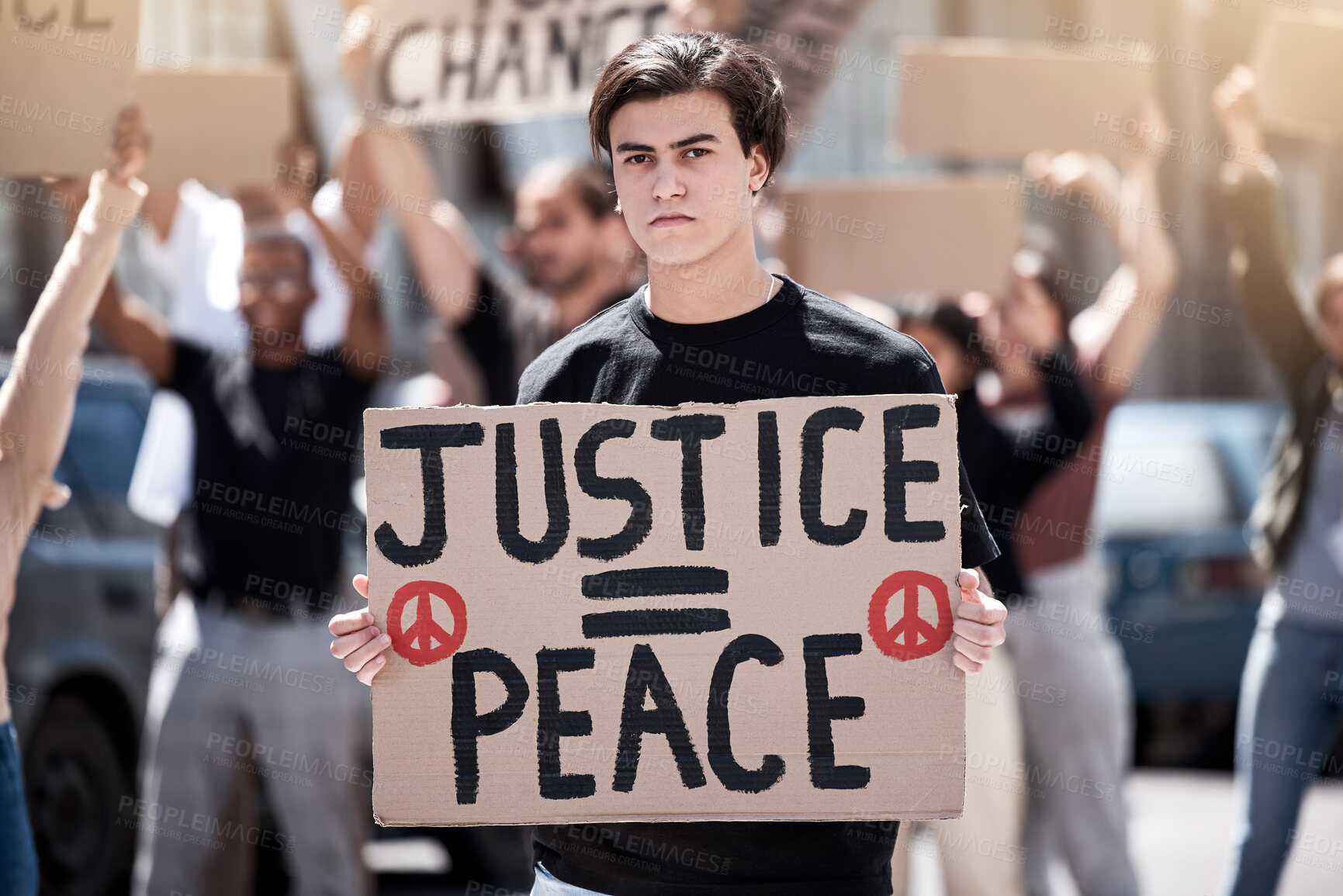 Buy stock photo Shot of a young man holding up a sign during a protest