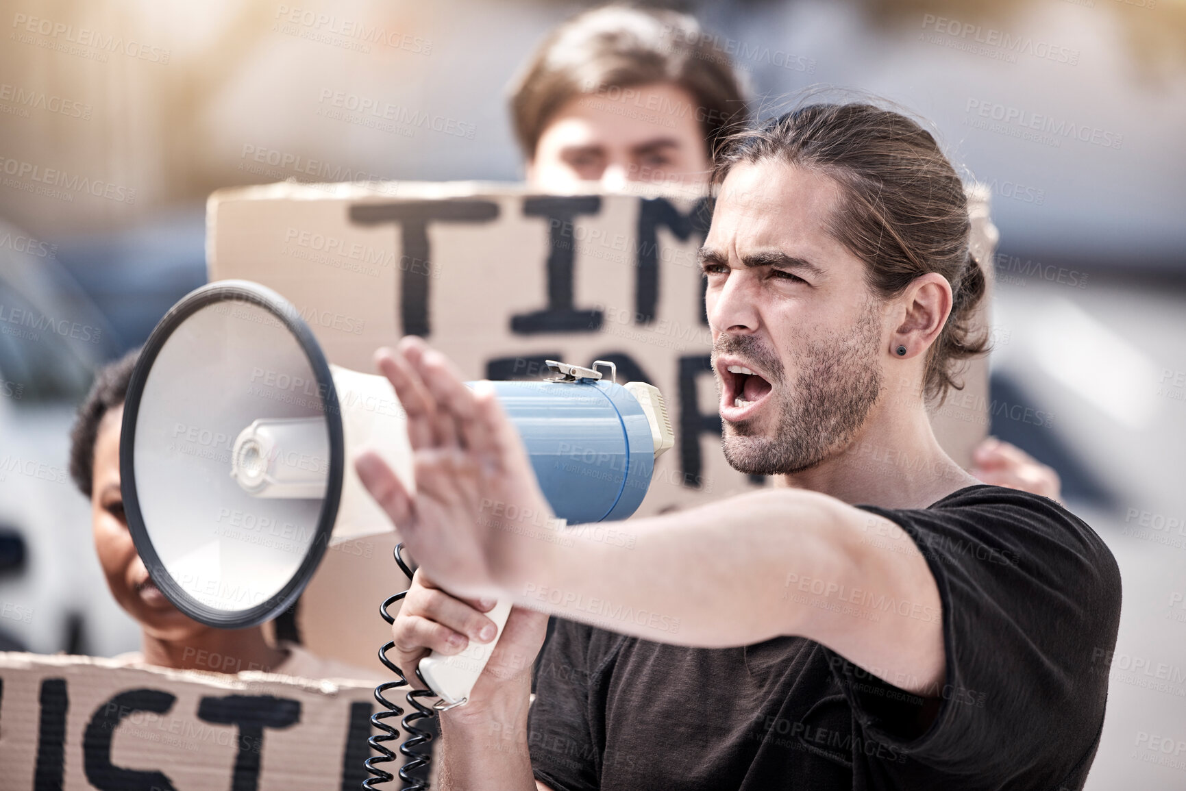 Buy stock photo Frustrated man, megaphone and protest with community for human rights, equality or change in society or city. Angry male person or activist screaming or yelling on loudspeaker in street riot or rally