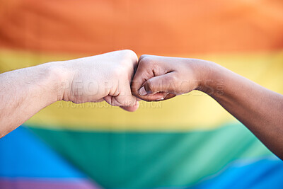 Buy stock photo Shot of two protestors bumping fists in support at a LGBTQ protest
