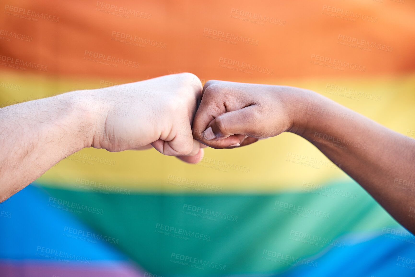 Buy stock photo Hands, fist bump and pride by rainbow flag for solidarity, diversity or support for freedom in community. People, march or parade with power, lgbtq and together with connection, equality or inclusion