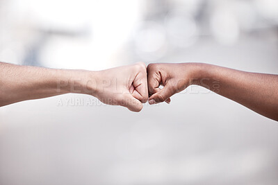 Buy stock photo Shot of two protestors fist bumping one another in solidarity