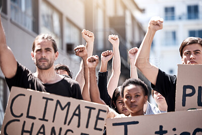 Buy stock photo Shot of a group of young people during a protest rally with their hands raised