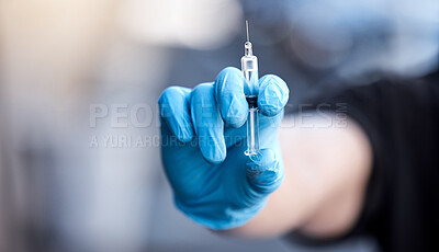 Buy stock photo Shot of a man holding a syringe with the covid vaccine