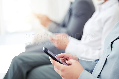 Buy stock photo Closeup shot of an unrecognisable businesswoman using a cellphone while sitting in line in an office