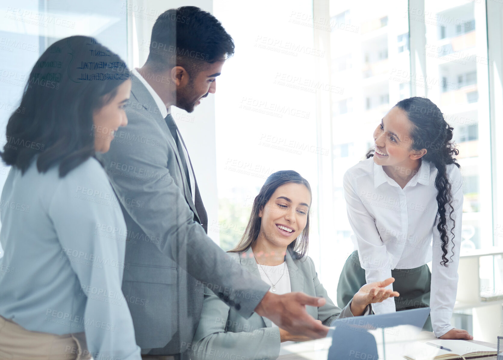 Buy stock photo Shot of a group of businesspeople working together on a laptop in an office