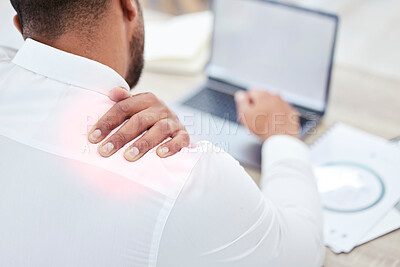 Buy stock photo Closeup shot of an unrecognisable businessman experiencing shoulder pain while working in an office