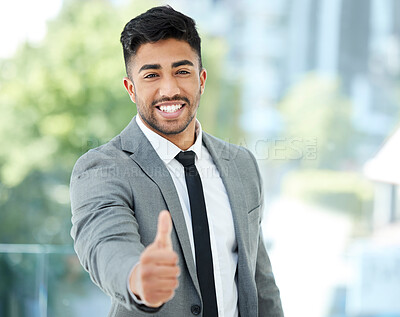 Buy stock photo Cropped portrait of a handsome young businessman reaching out for a handshake while standing in his office