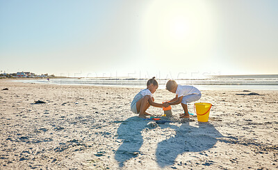 Buy stock photo Boy, girl or sandcastle with bucket, beach or children playing outdoors on vacation in summer. Kids, siblings or plastic toys for building, construction game and holiday for bonding by ocean together