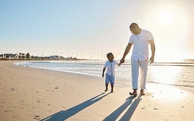 Buy stock photo Holding hands, walking and dad with child at beach for bonding on summer holiday, vacation and weekend. Morning, family and happy father with young boy for relationship, adventure and relax outdoors