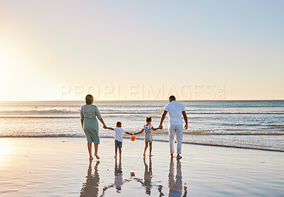 Buy stock photo Beach, parents and children with holding hands for walking, playful and bonding together on vacation holiday. Family, mother and father with kids for security, connection and sunset in ocean by back