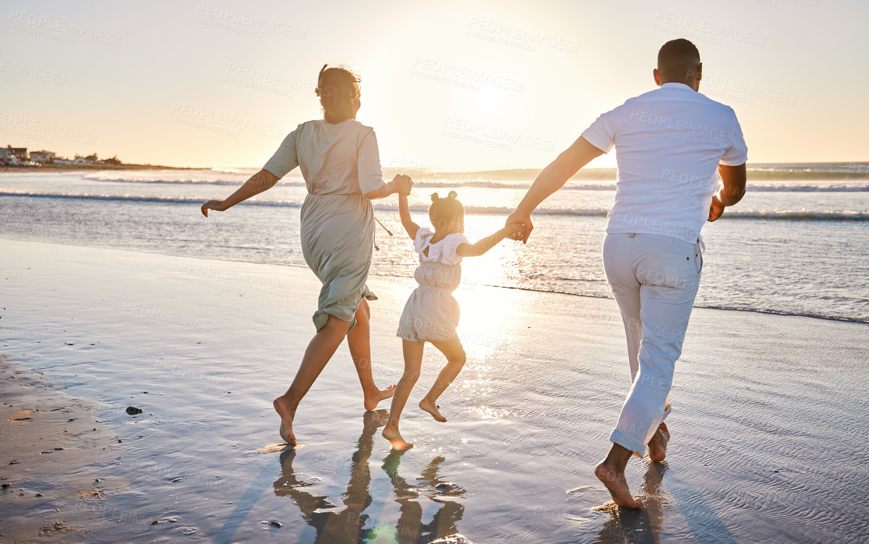 Buy stock photo Beach, parents and child with holding hands for running, playful and bonding together on vacation holiday. Family, mother and father with girl for security, connection and air game in ocean by back