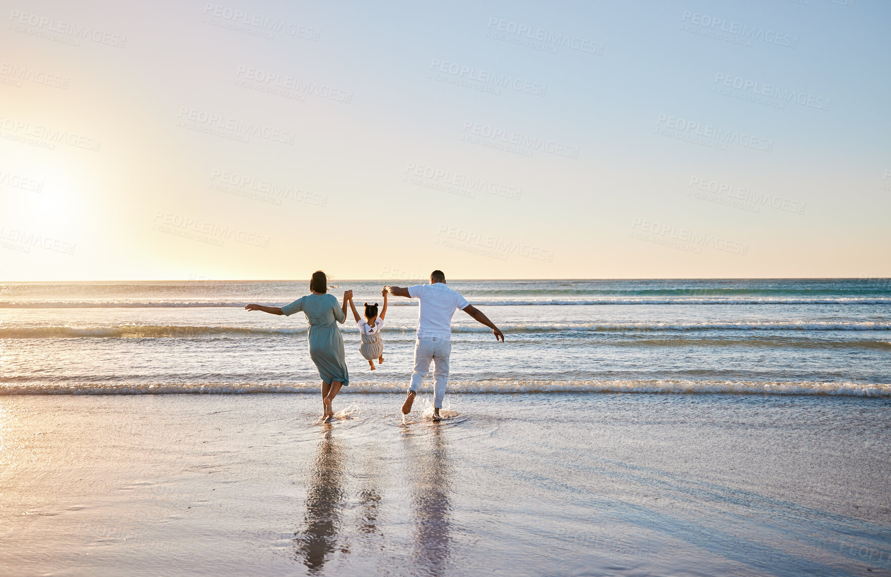 Buy stock photo Holding hands, waves and parents with child at beach for bonding on summer holiday, vacation and weekend. Morning, family and mom, dad and girl swing for fun, adventure and relax outdoors in nature