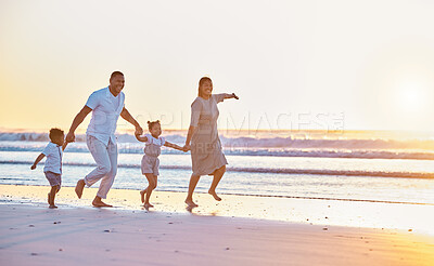 Buy stock photo Family, beach and running together at sunset, playing games and shore for holiday bonding. Parents, children and walking on sand for vacation fun, weekend trip and travel to coast for adventure