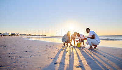 Buy stock photo Parents, sandcastle or kids at beach for playing, holiday or travel on break with boy, girl or family. Bonding, mom or father with children at sea on vacation together for games or sunset to relax