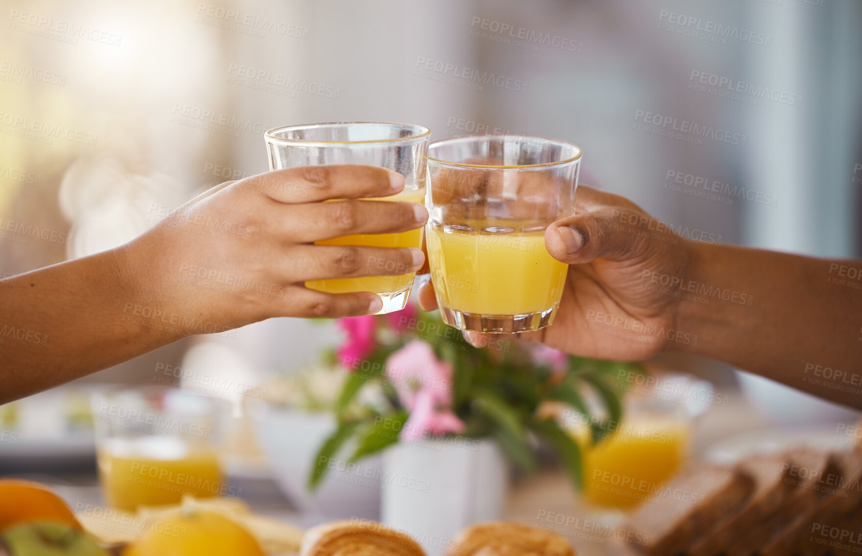 Buy stock photo Couple, cheers and orange juice in home with brunch, food and gratitude with mimosa at event. Table, glasses and celebration toast in dining room together with people and party with feast and meal