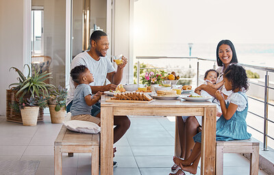 Buy stock photo Shot of a young family having lunch together at home